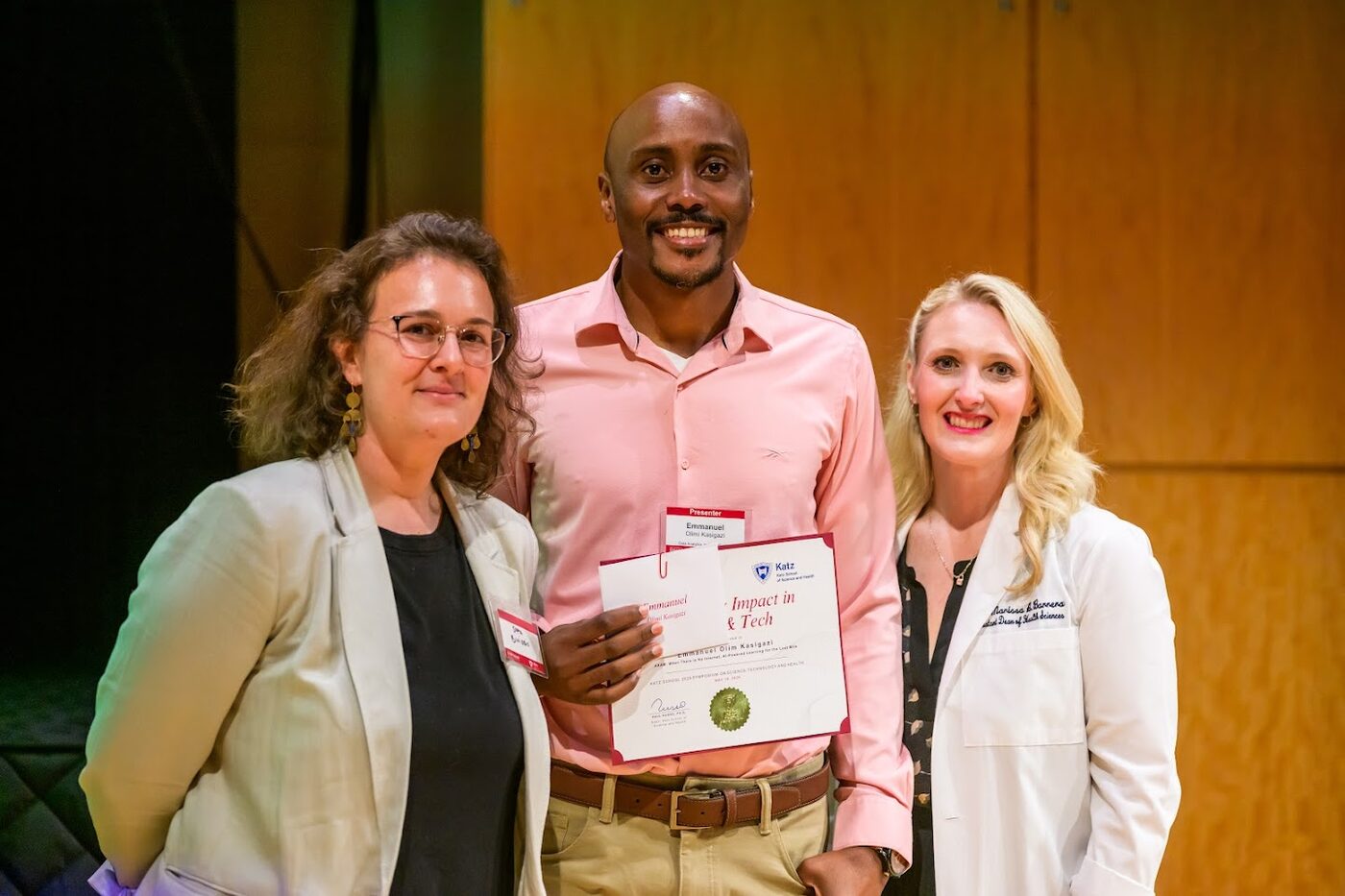 Emmanuel receiving the Outstanding Impact in Science & Tech recognition with Katz School deans